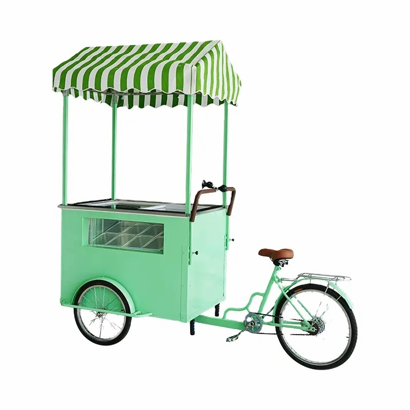 Green movable ice cream tricycle equip with canopy and display counter.